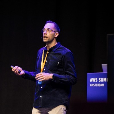 Ioannis Moustakis speaking on stage at AWS Summit Amsterdam